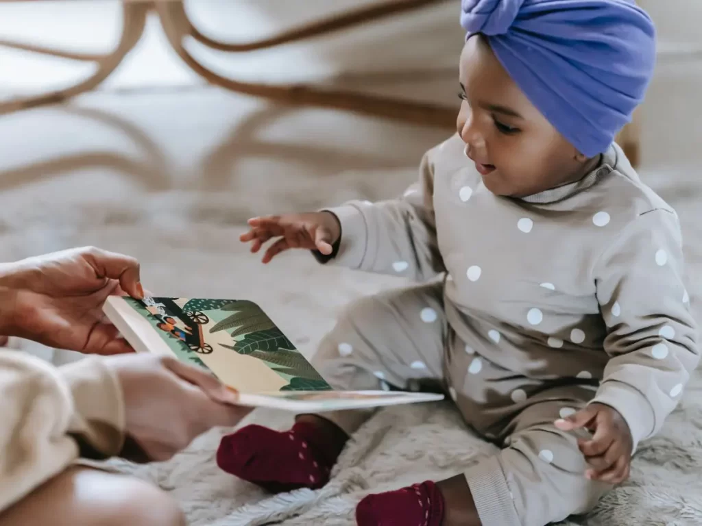 baby looking at a book using phonics to learn how to read