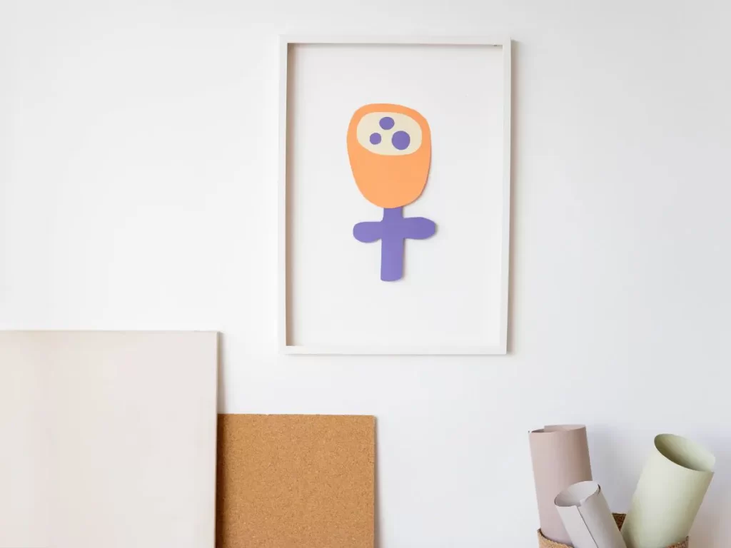 Parents Organize Children's Artwork by hanging their child's art on the wall in a frame.