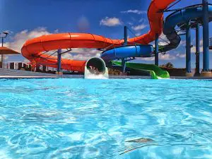 red and blue waterslides with a pool