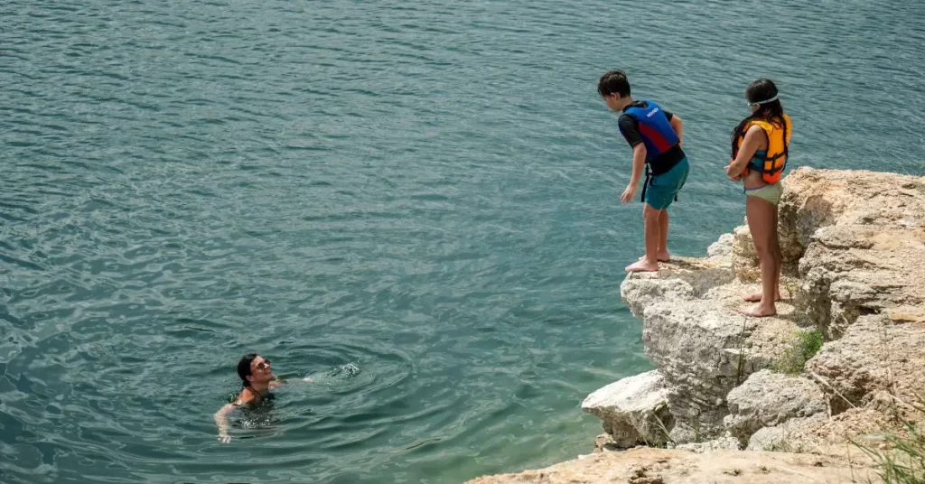 child jumping into lake getting out of comfort zone