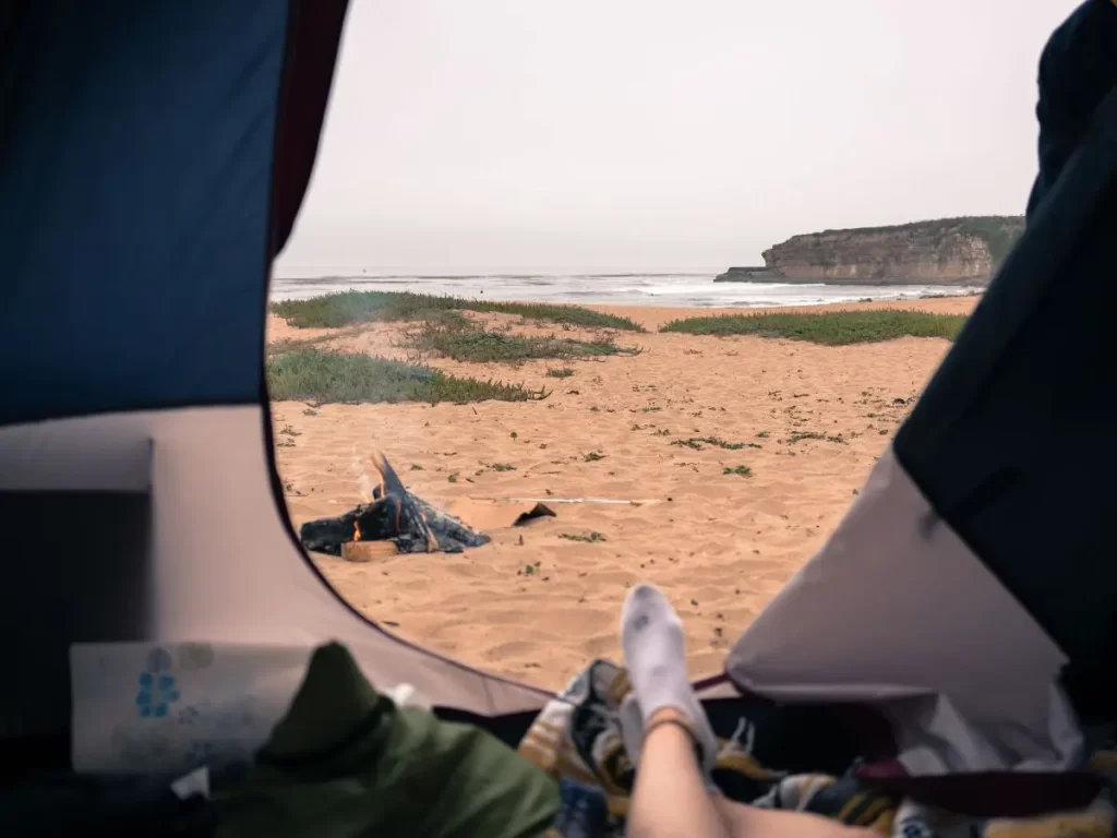 View from a tent looking out at sand