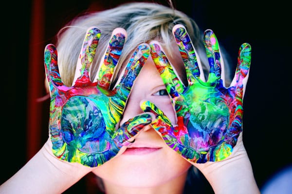 kid with paint on their hands