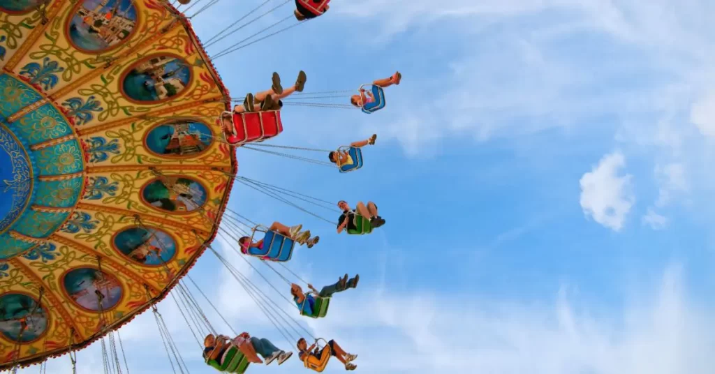 families on an amusement park swing