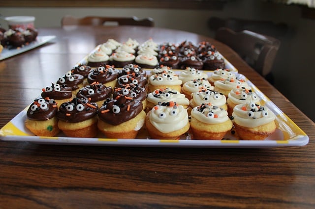 A pile of donuts with chocolate and vanilla frosting