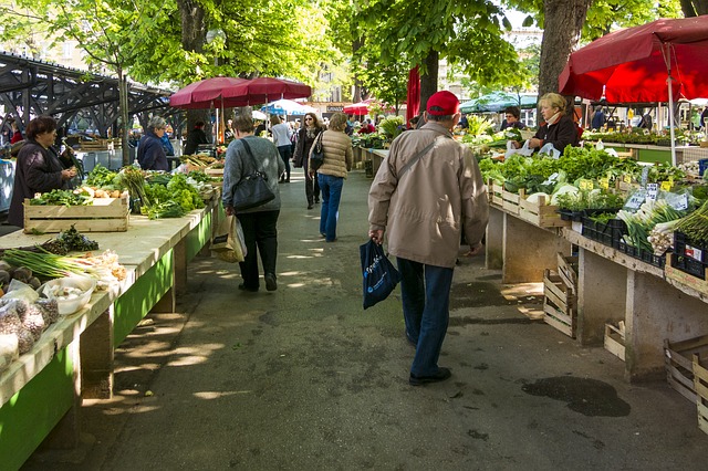 People Visiting a farmers market in the fall