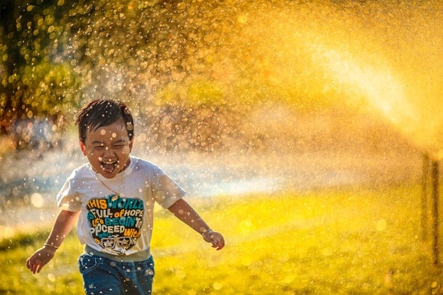 kid in a sprinkler