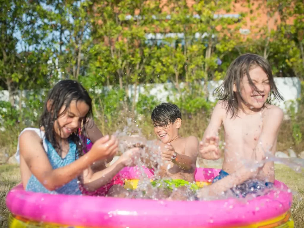 Kids saying cool this summer by splashing in a kiddie pool