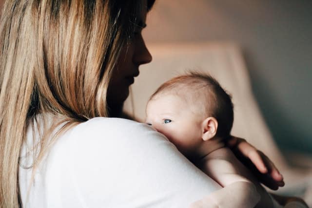 Mother with newborn baby trying to get them to go to sleep