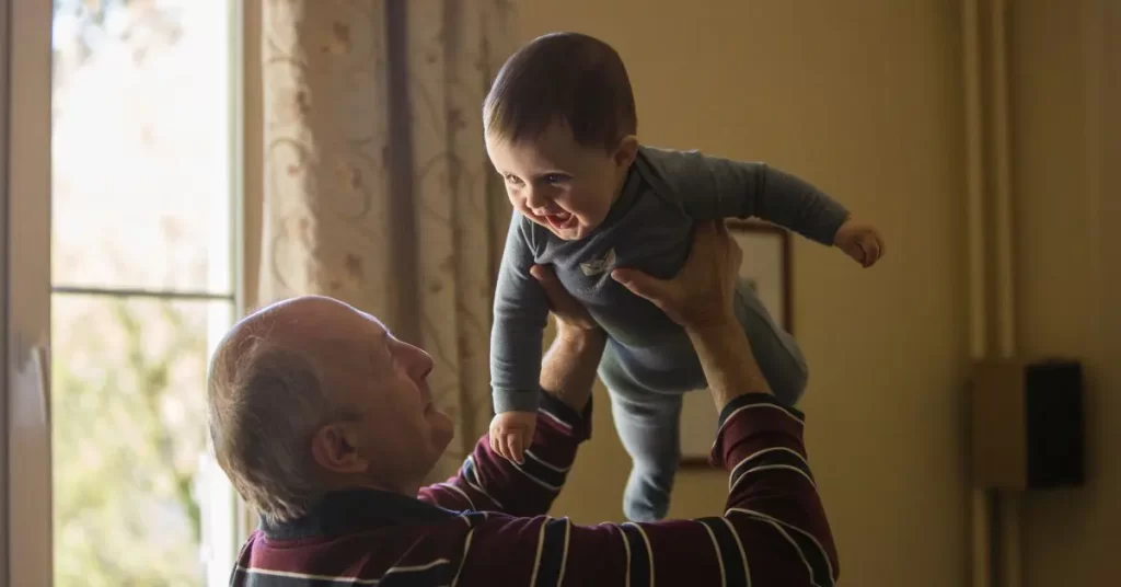 Grandpa holding smiling baby up in the air