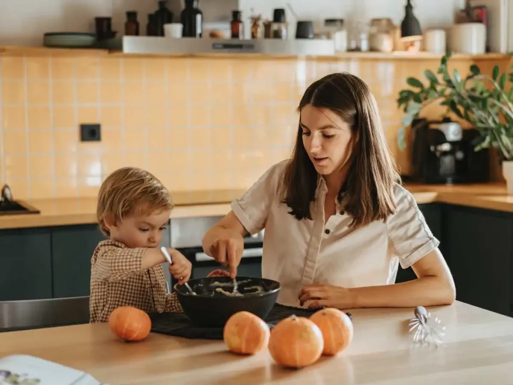 kid and mom at kitchen counter baking