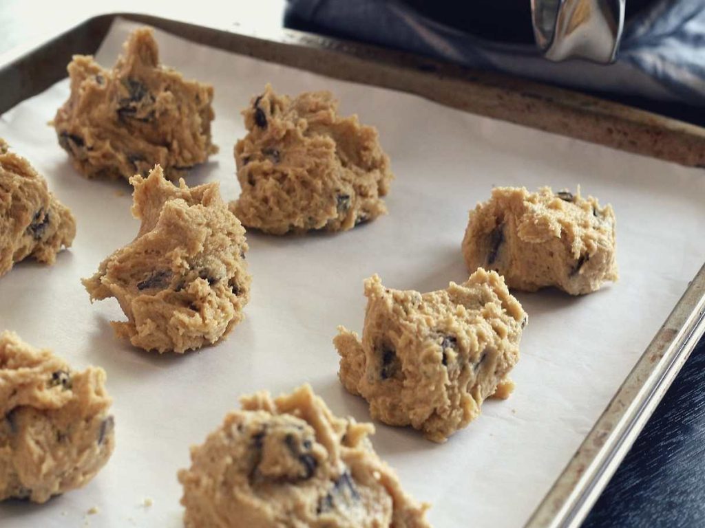 Oreo chocolate chip cookie dough on a parchment sheet on a baking tray