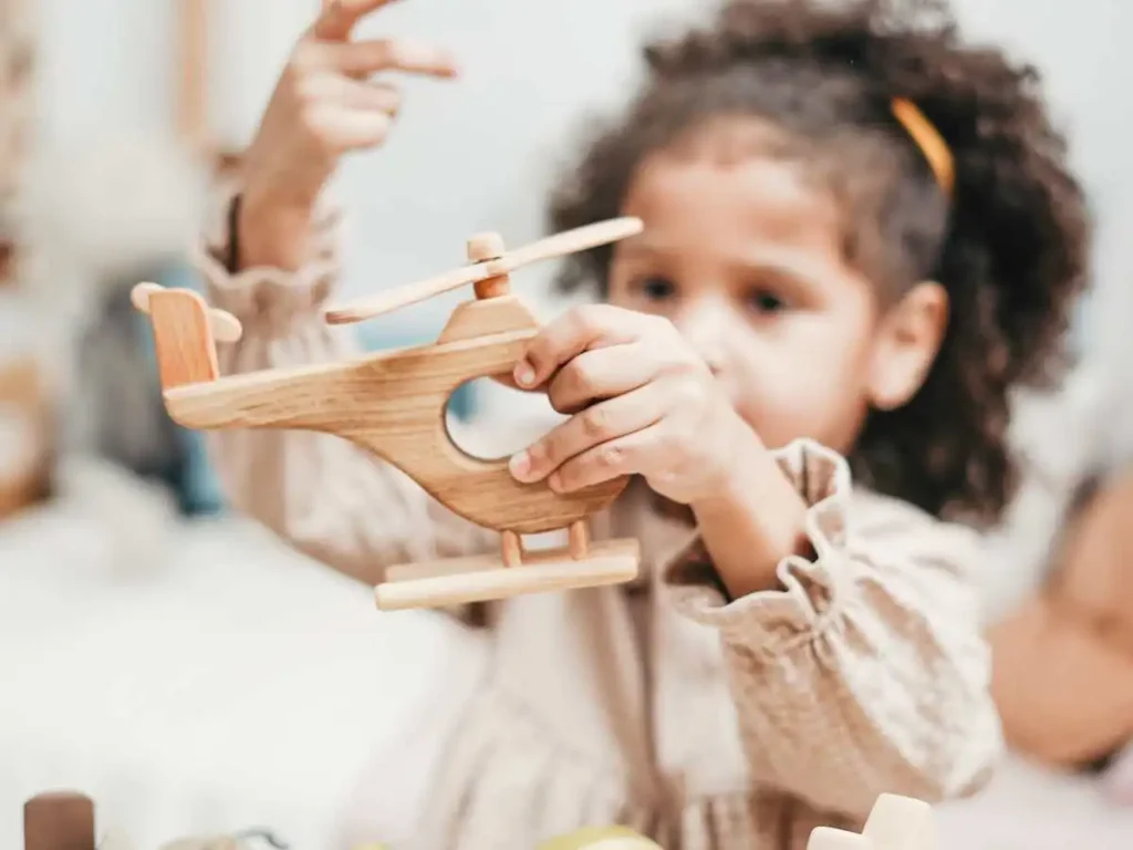 kid holding a helicopter and playing