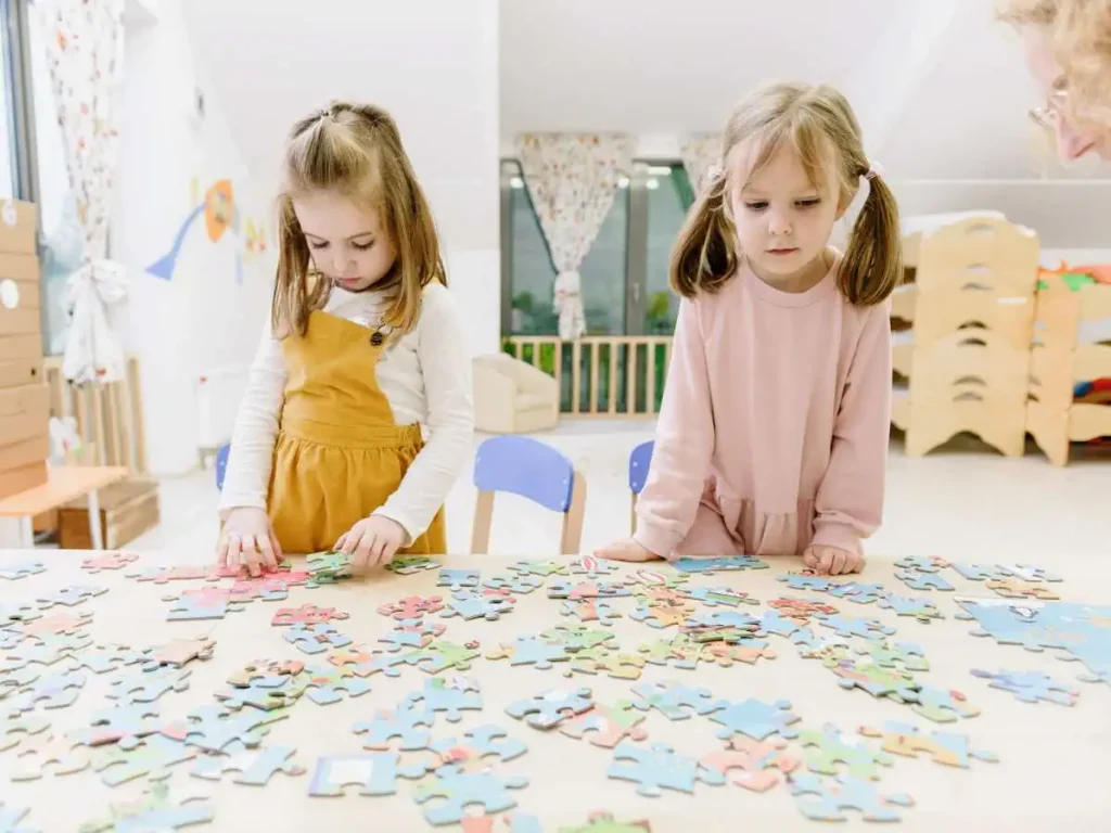two girls playing with puzzles