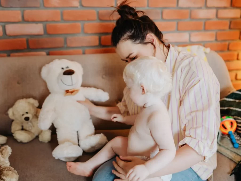 Mom teaching baby the sign for bear