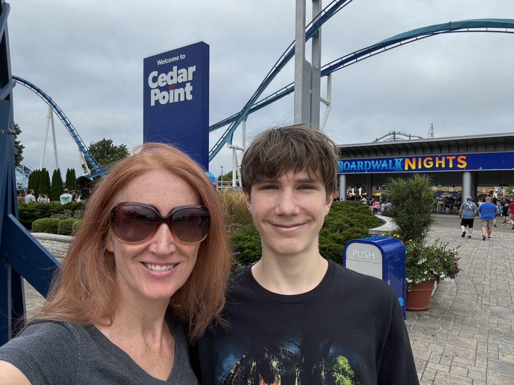 Cedar point entrance with mom and son and sign in back