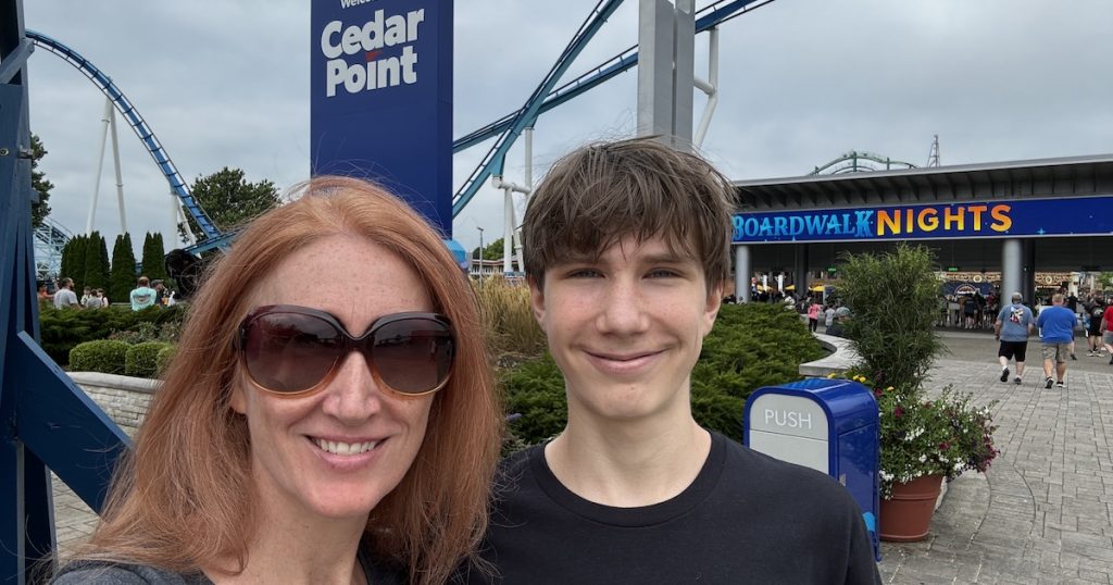 Cedar point entrance with mom and son and sign in back